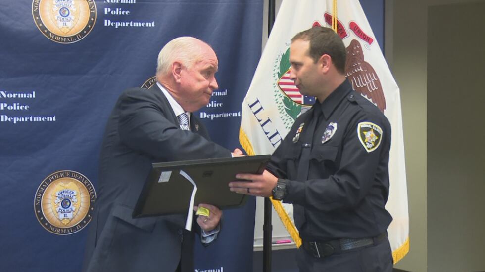 State Rep. Dan Brady congratulates Normal Police officer