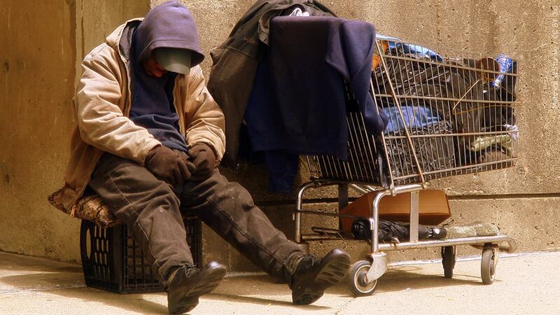 File photo of a homeless man on a city street corner.