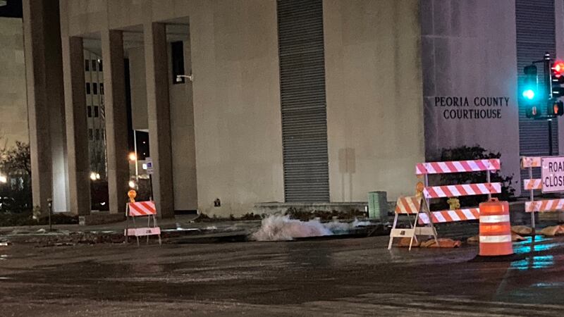 Hamilton Blvd. in Peoria near the Peoria County Courthouse is blocked off due to water on the...