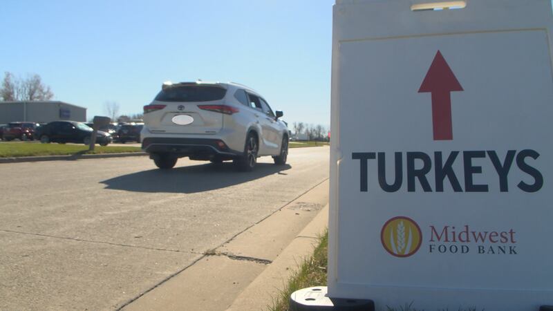 A car entering the line for a Thanksgiving food distribution