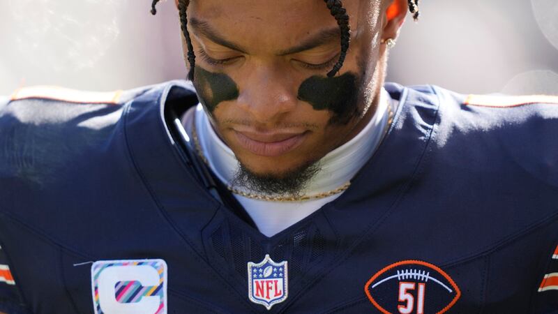 Chicago Bears quarterback Justin Fields walks to the locker room injured during the second...